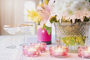 table setting for an engagement party including champagne glasses, candles, and flowers