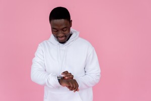 young man looking at his smart watch