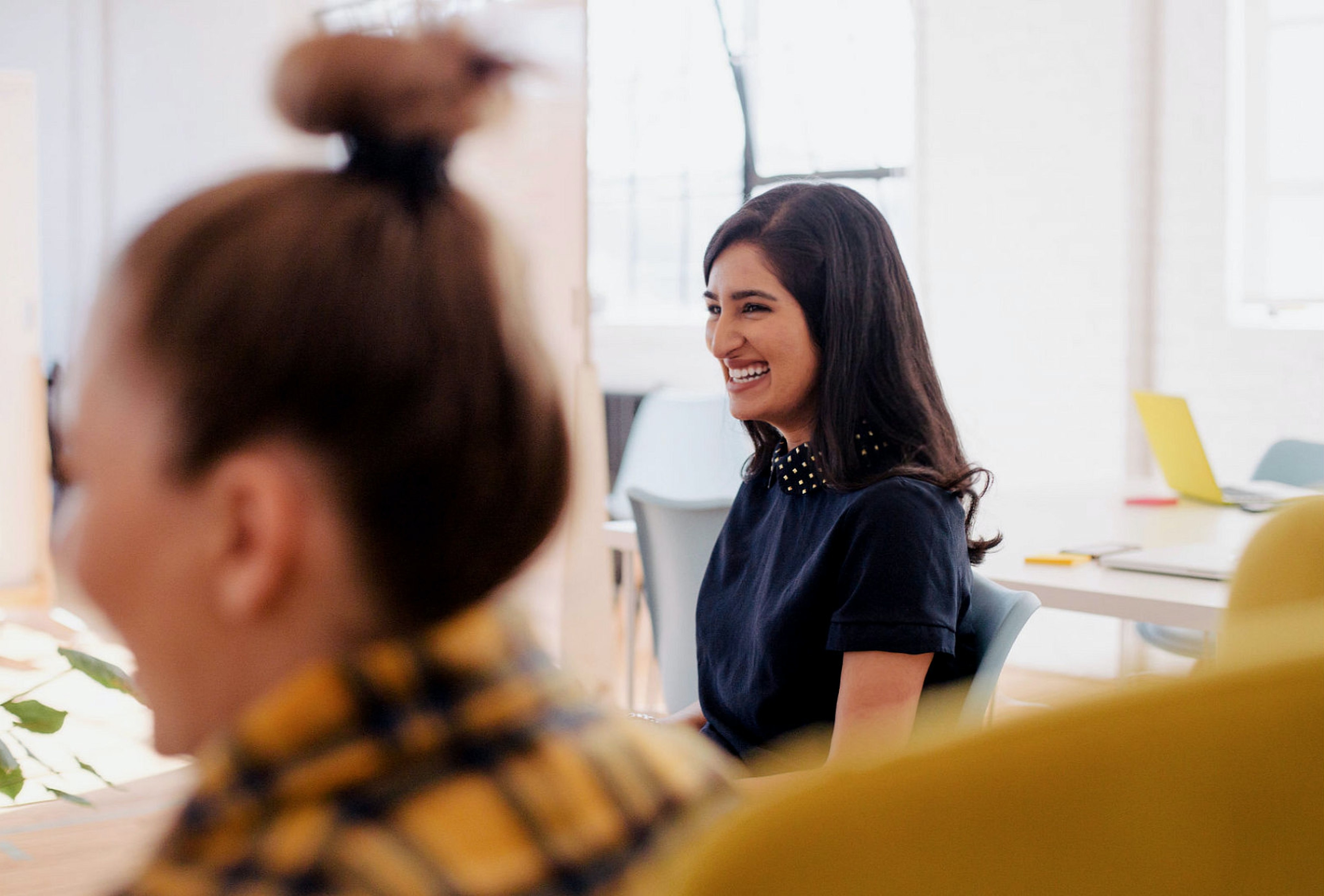 business women smiling cordially in a meeting together