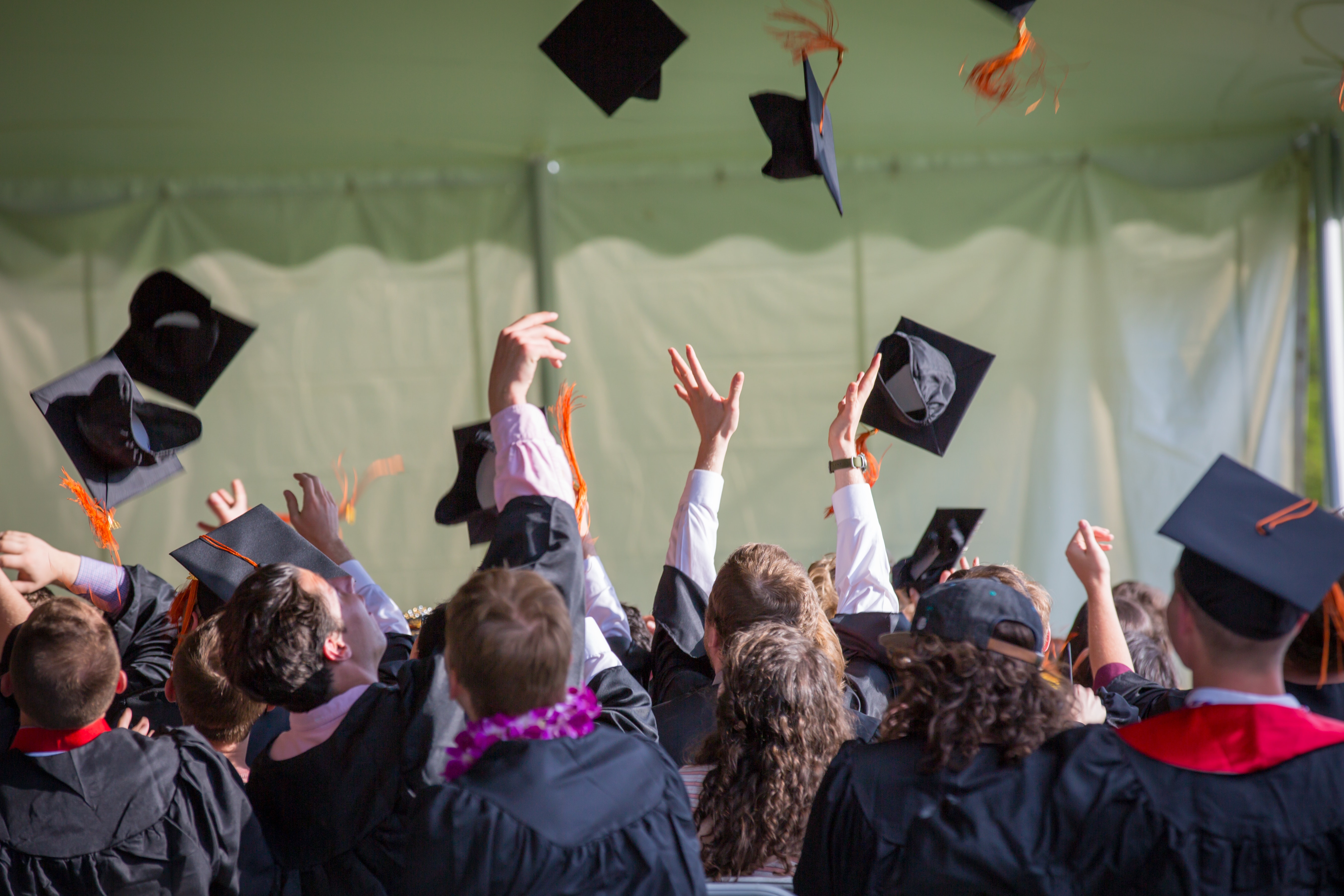 graduates tossing their caps in the air