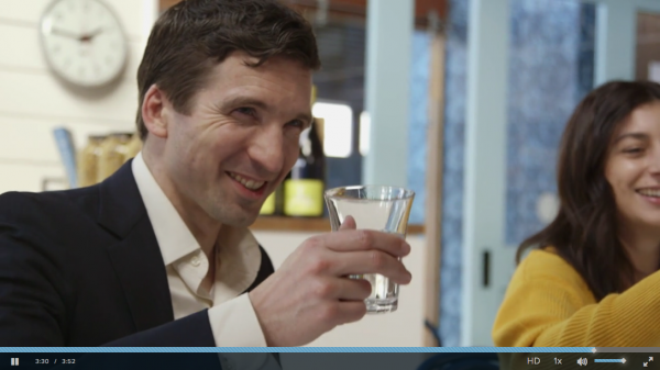 photo: daniel post senning raising a glass and smiling