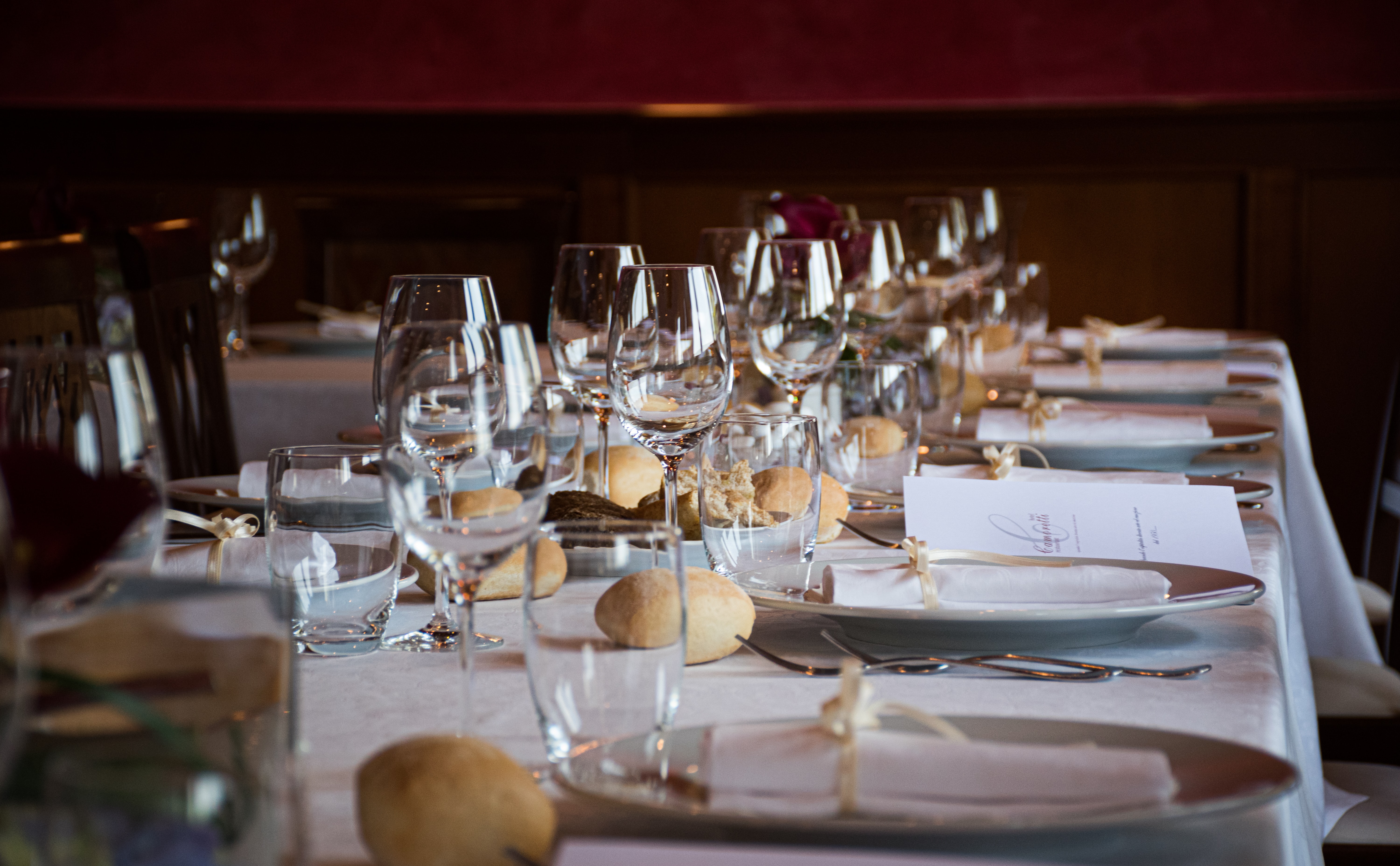 formal table setting with prominent clear wine glasses